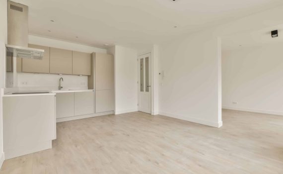 an empty living room and kitchen in a house