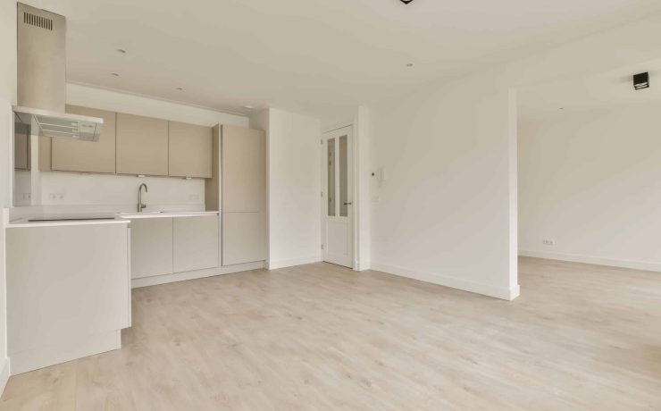 an empty living room and kitchen in a house